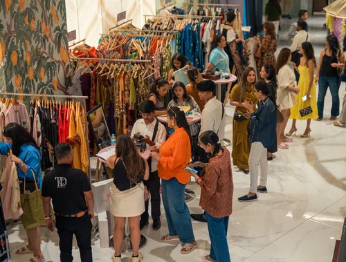 Shoppers exploring brand tables at The Pop Up Story